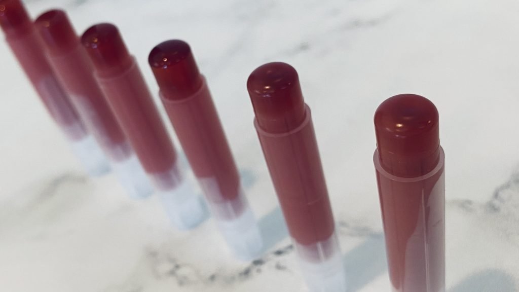 Detailed shot of DIY alkanet tinted lip balm tops for best customer experience.